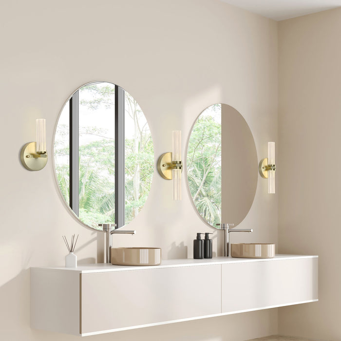 Bathroom with Aberdeen brass wall lights between oval mirrors above a white double vanity