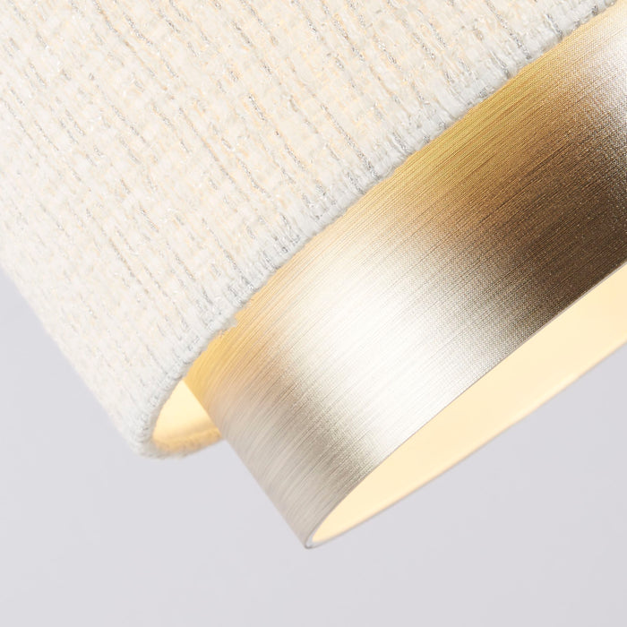 Close-up of the Amelie shade's woven white fabric meeting its brushed champagne silver band