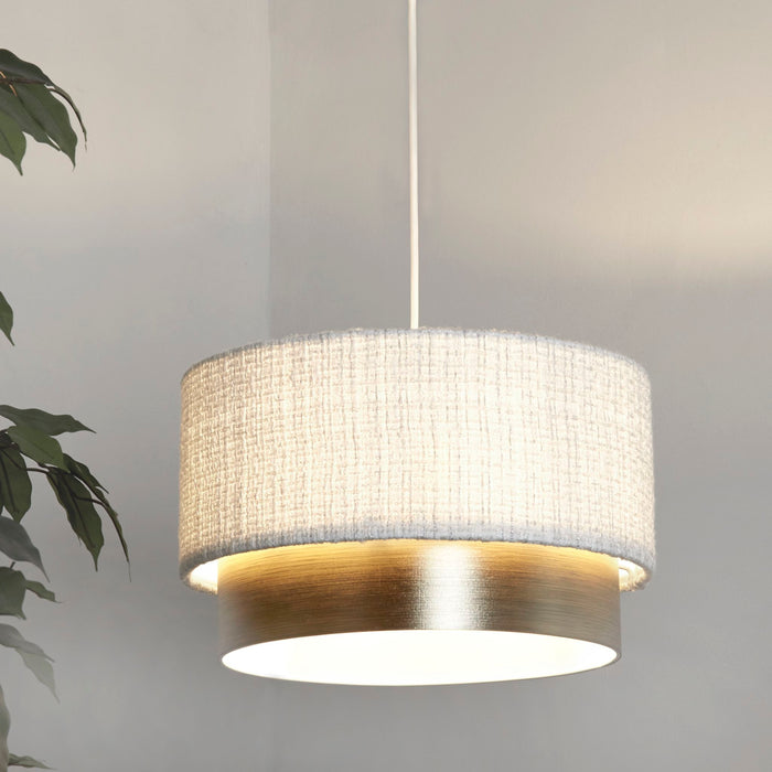 Amelie two tier pendant shade lit above a grey room with a leafy houseplant alongside