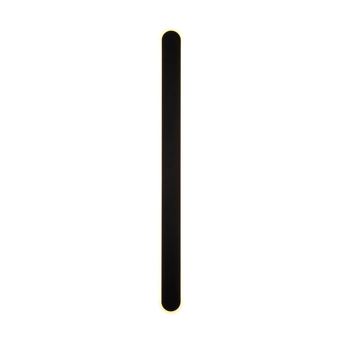 Bordo sand black LED wall light lit, slim vertical bar edged with a soft warm white glow