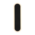 Bordo sand black LED wall light lit as a slim rounded oblong with a glowing warm white outline