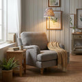 Burley Rechargeable Brass Floor Lamp with Ikat Pearl Grey Shade casting warm light beside a grey armchair.