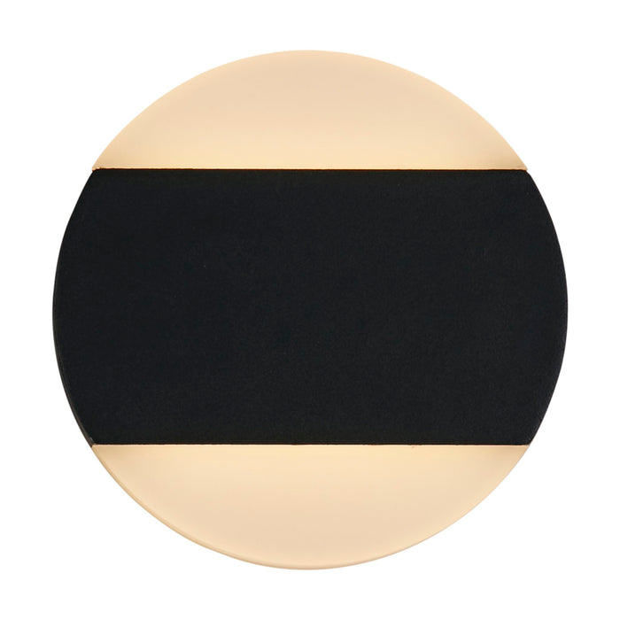 Cavern black LED wall light lit as a round disc with glowing top and bottom halves