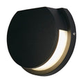 Chiswick black LED wall light lit as a round disc with a crescent glowing diffuser