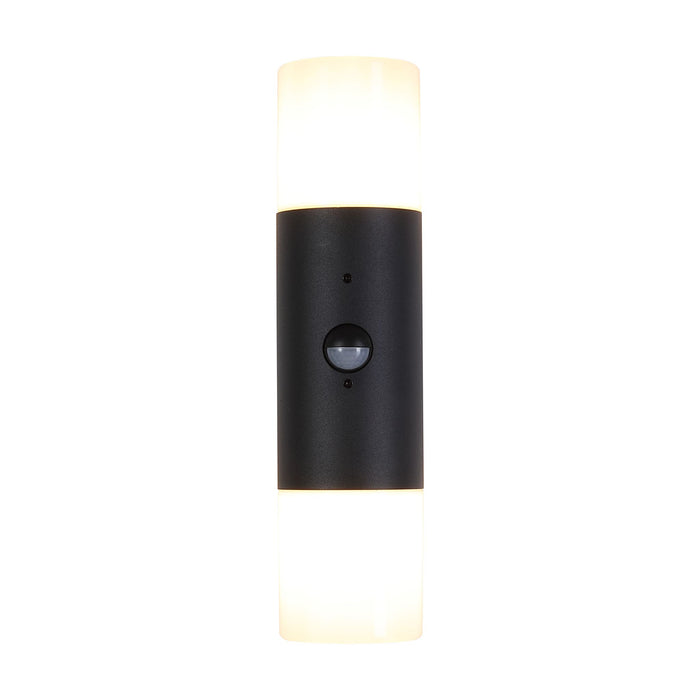 Colorado black up and down wall light lit with opal diffusers and a central PIR sensor