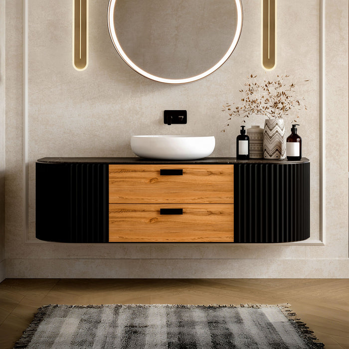 Bathroom with Couper brass LED wall lights either side of a round mirror and black vanity