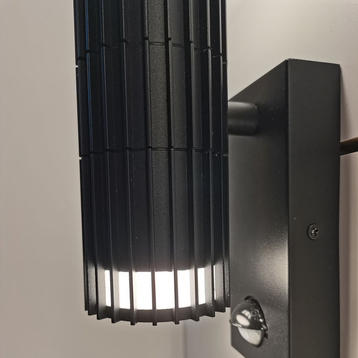 Close-up of the Detroit light's ribbed black slats and glowing lower diffuser