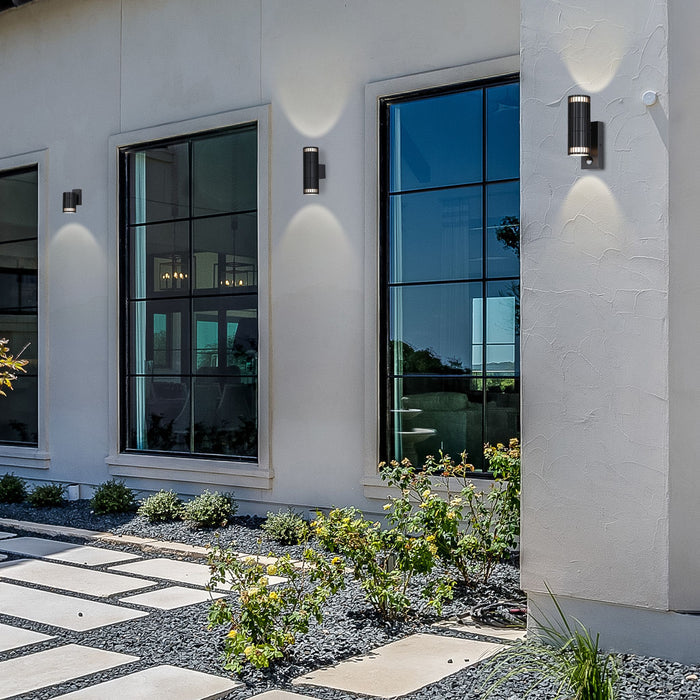Detroit black wall lights up and down lighting a white rendered house between tall windows