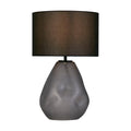Devon table lamp with dimpled frosted grey glass base lit under a black linen shade