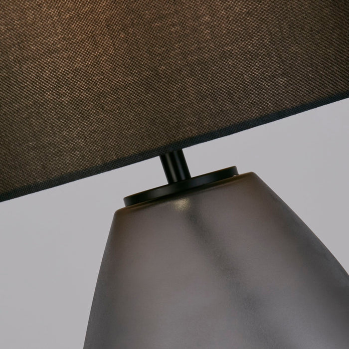 Detail of the Devon lamp's frosted dimpled glass base meeting its black linen shade