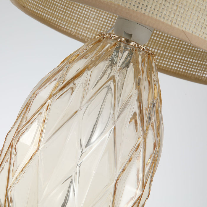 Close-up of the Diane lamp's faceted champagne glass base and rattan shade edge
