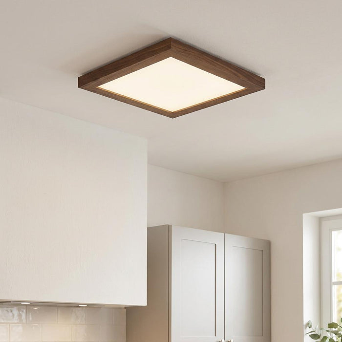 Square walnut-framed LED panel light mounted flush to a white kitchen ceiling.
