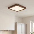Square walnut-framed LED panel light mounted flush to a white kitchen ceiling.