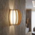 Modern wall light featuring a white glass shade and curved wooden slats on a textured beige wall.
