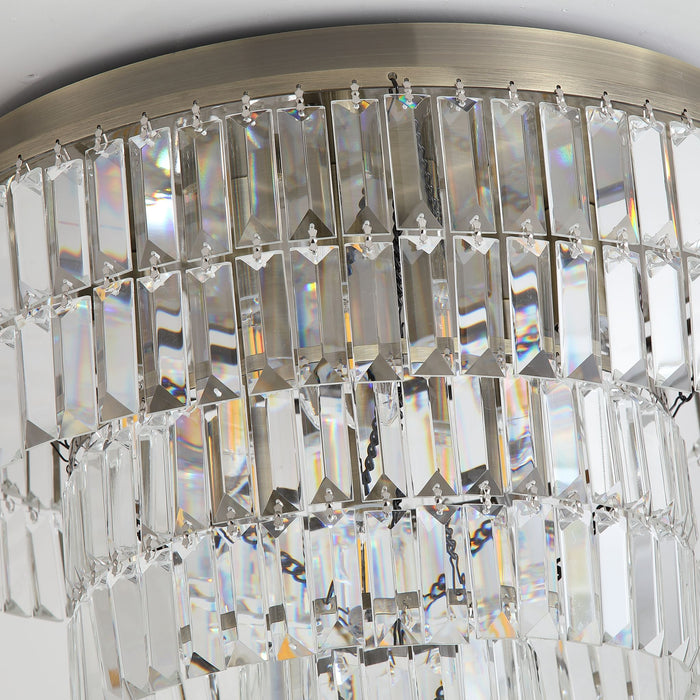 Detail of Empire's brushed brass ring and cascading rows of clear rectangular crystal prisms