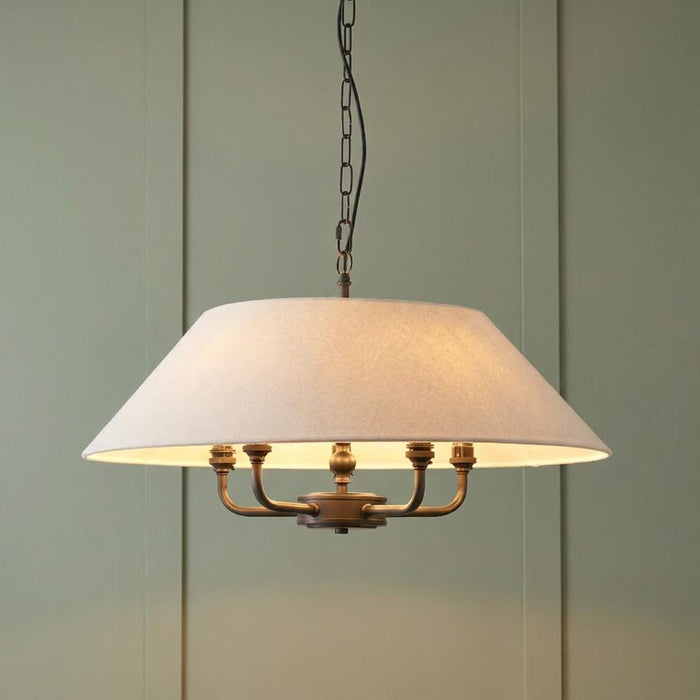 Endon Lille antique black 5-light pendant with a cream linen shade against a sage green panelled wall.