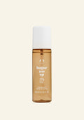 Perfume bottle labeled ' butter me up' on a beige background