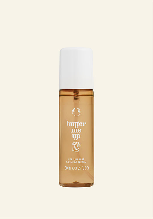 Perfume bottle labeled ' butter me up' on a beige background