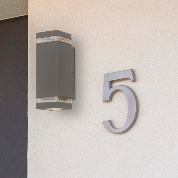 Houston grey wall light on a white rendered house wall beside a metal number five