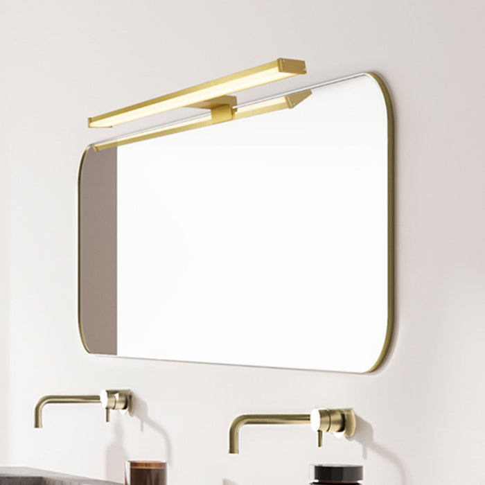 Bathroom with the Kos gold LED light over a rounded mirror and twin brass basin taps