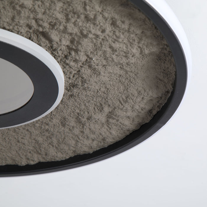 Close-up of the Lumadisc light's rough stone-effect surface and white inner rim