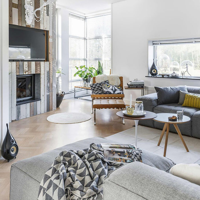 Open-plan living room with the Lumadisc black LED ceiling light above grey sofas and fireplace