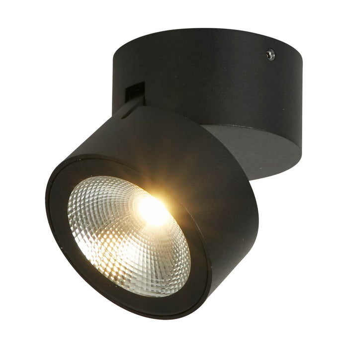 Manhattan matt black LED wall light lit as an adjustable round surface spotlight