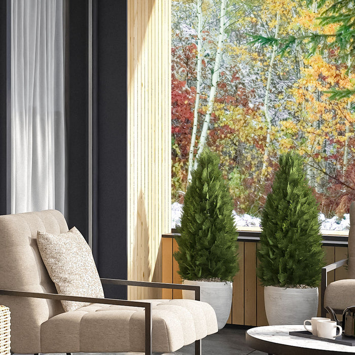 Manhattan black spotlight lighting a lounge corner with a cream armchair and window planters