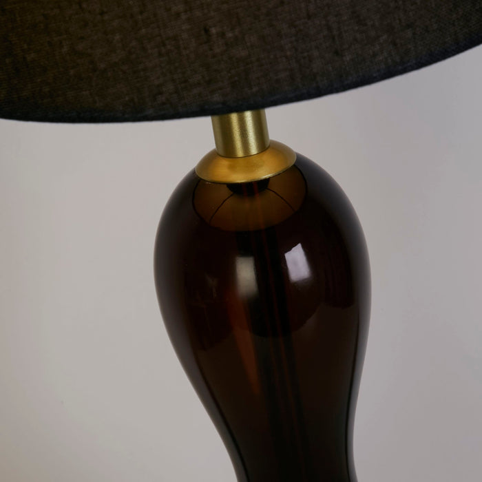 Detail of the Marakesh lamp's ombre brown glass body and brass shade collar