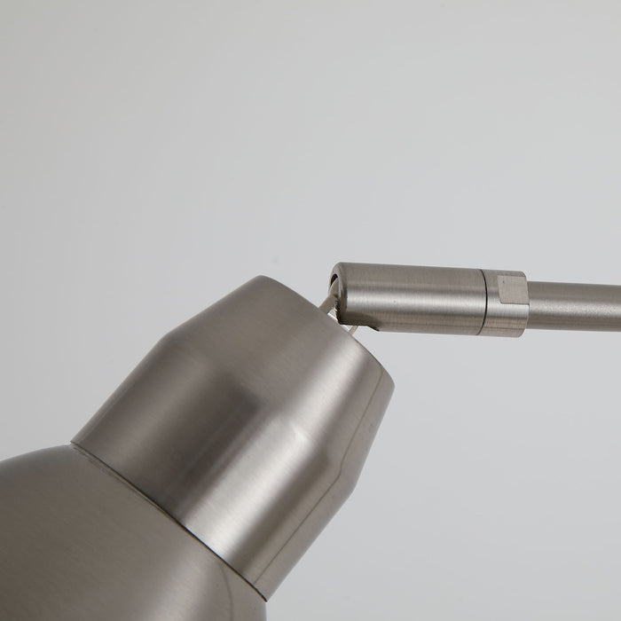 Close-up of the satin nickel tapered shade and its adjustable knurled joint on the curved stem