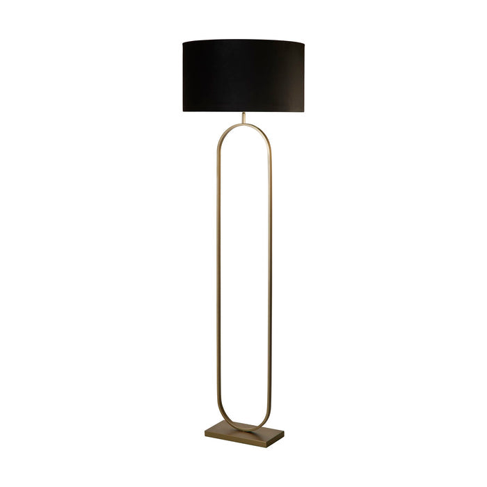 Modish bronze floor lamp unlit on a white studio background with black velvet drum shade