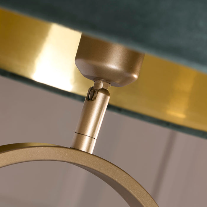 Detail of the Modish bronze shade fitting and gold trim meeting the green velvet drum shade