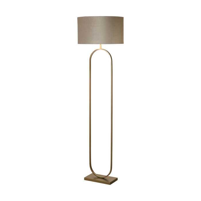 Modish bronze floor lamp lit with a taupe velvet drum shade above a slender oval frame