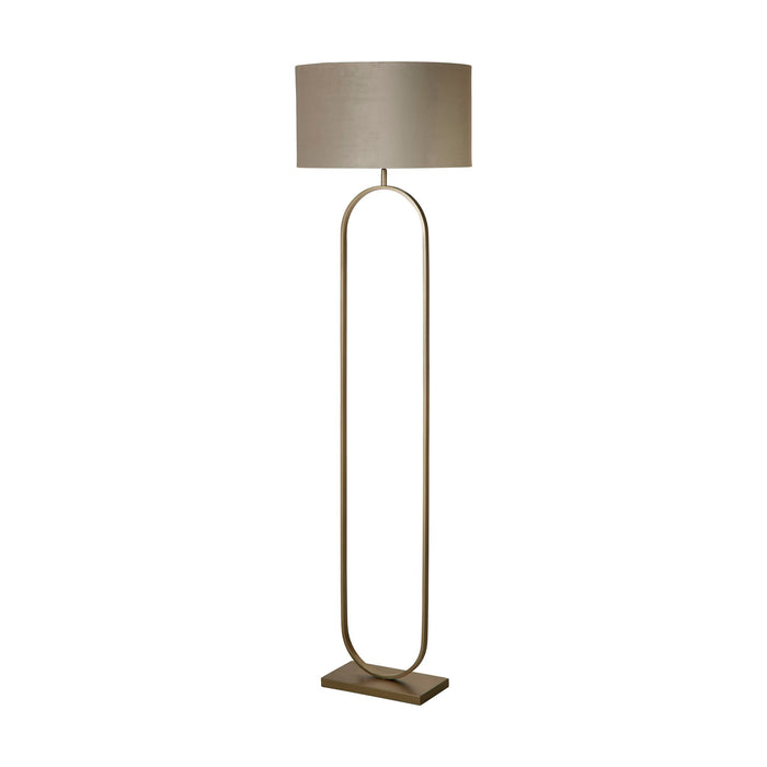 Modish bronze oval floor lamp unlit on white with taupe velvet lampshade and flat base