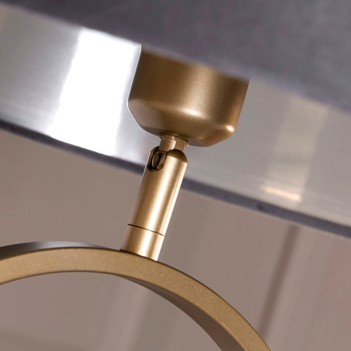 Close-up of the bronze fitting and oval hoop beneath the dark grey velvet shade
