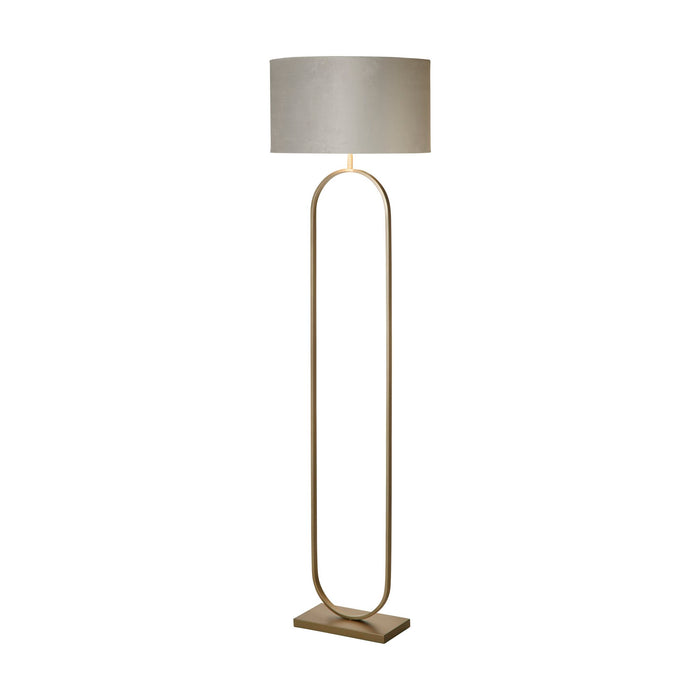 Modish bronze metal floor lamp lit with a grey velvet drum shade on an oval hoop stand