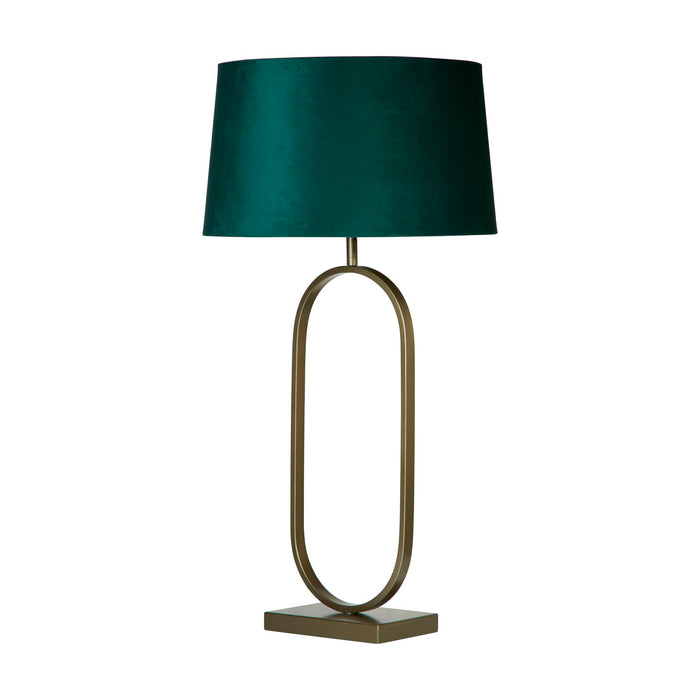 Modish table lamp unlit on white showing antique bronze oval base and emerald velvet shade