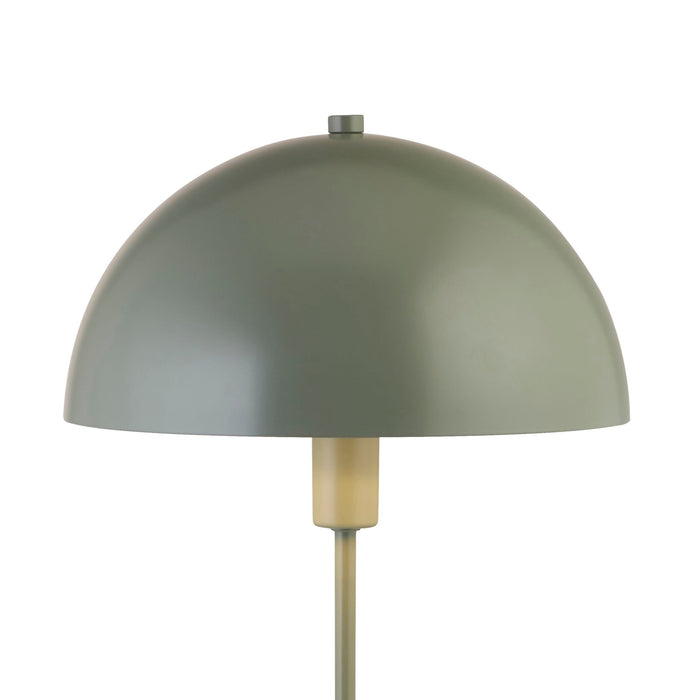 Detail of the Mushroom lamp's matt green dome shade meeting its brass bulb holder