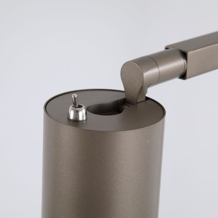 Detail of the Office desk lamp's latte metallic head, toggle switch and pivoting arm