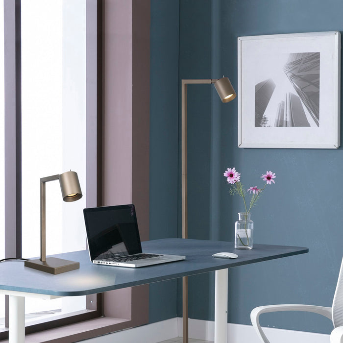 Office latte desk lamp on a home office desk with laptop, flowers and matching floor lamp