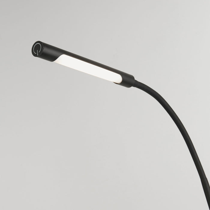 Close-up of the Plume lamp's black gooseneck head with LED strip and touch dimmer ring