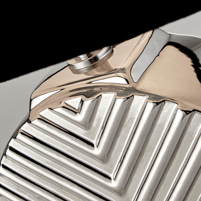 Close-up of the Regent lamp's polished chrome chevron relief base and fitting
