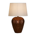 Rosetta bronze table lamp with faceted petal-patterned resin base and lit cream shade