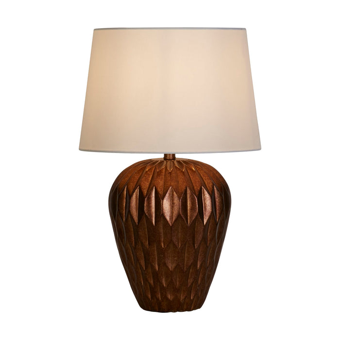 Rosetta bronze table lamp with faceted petal-patterned resin base and lit cream shade