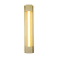 Sacramento gold outdoor wall light lit with a seeded glass tube between brushed gold brackets