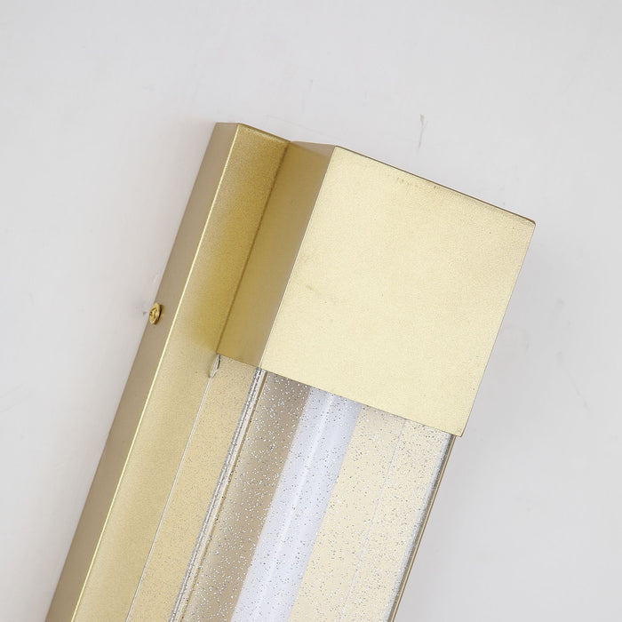 Close-up of the Sacramento light's brushed gold bracket and sparkling seeded glass tube