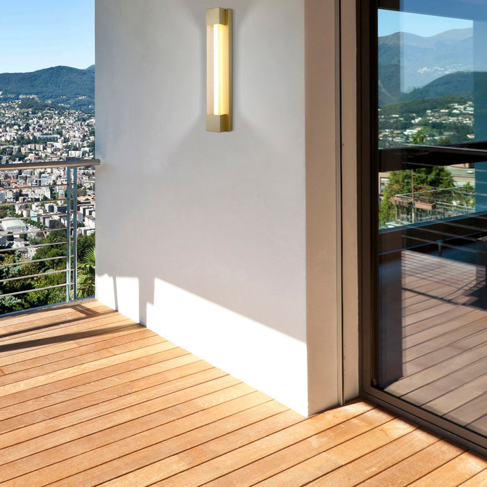 Sacramento gold wall light on a rendered balcony wall beside decking and a hillside view