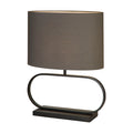 Sleek matt black table lamp with oval hoop base and lit grey oval fabric shade