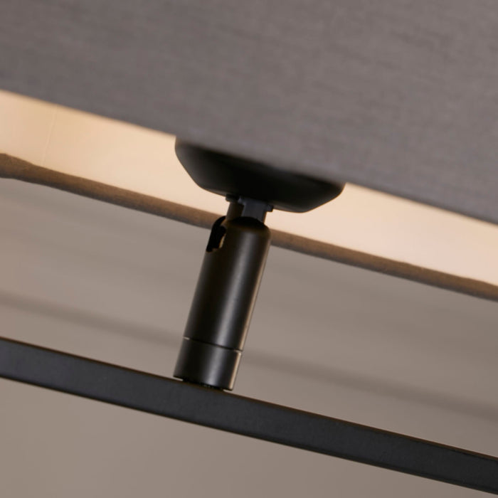 Close-up of the black holder and hoop bar under the Sleek grey oval fabric shade