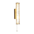 Vibrate matt gold IP44 bathroom wall light glowing behind a rippled clear glass tube with pull cord